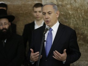 Israeli Prime Minister Benjamin Netanyahu delivers a speech, on March 18, 2015, at the Wailing Wall in Jerusalem following his party Likud's victory in Israel's general election. Netanyahu vowed to ensure the "welfare and security" of Israelis, after his rightwing Likud party won a surprise general election victory.  AFP PHOTO / THOMAS COEX