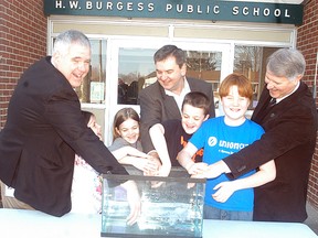 Submitted photo: In an effort to find out how cold ice water is and the effects on the body, students at H.W. Burgess Public School dip their arms in a bucket of ice water. Union Gas donated $5,000 to the St. Clair Conservation Authority for its spring water awareness program. The program teaches students about the power and potential danger of water. Making the donation are, from left to right, Chris Young administration manager, STO, Union Gas; Dave Lamoureux, director of storage and transmission operations, Union Gas; Steve Arnold, chair, St. Clair Region Conservation Authority, plus Braeden, Ainsley, Raleigh and Rory Young, students at H. W. Burgess Public School.