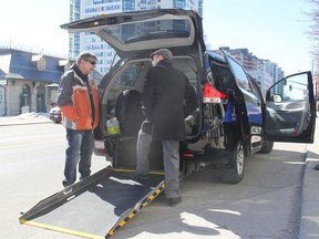 Driver Jim Stewart, left, shows Mayor Bryan Paterson the workings of the new accessible taxi that brings to three the number of the special vans on Kingston streets. (Michael Lea/The Whig-Standard)