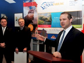 Brockville Mayor David Henderson speaks at the podium while Leeds-Grenville MP Gord Brown, left, and Aquatarium steering committee chairman Tony Barnes listen during a press conference on Friday, March 13. (RONALD ZAJAC/The Recorder and Times)