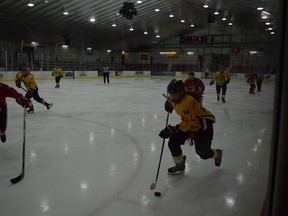 Mel Nolan (in gold) skates by her opponent at the OFSAA Girls Hockey Tournament in Kenora earlier this month. (Submitted)