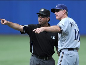 Milwaukee Brewers manager Ron Roenicke argues a call with first base umpire Phil Cuzzi during MLB action against the Toronto Blue Jays at Rogers Centre. (Dan Hamilton/USA TODAY Sports)