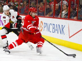 Mar 17, 2015; Raleigh, NC, USA; Carolina Hurricanes defensemen Ryan Murphy (7) skates with the puck against the Ottawa Senators forward Kyle Turris (7) during the 1st period at PNC Arena. Mandatory Credit: James Guillory-USA TODAY Sports