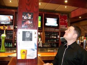 St. Louis Bar and Grill owner Luke Rochefort looks up at the empty spot where a prize firefighter's helmet was hung. The family souvenir was swiped last week and Rochefort is desperate to get it returned.
Alexandra Moscato/Ottawa Sun