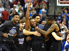 The Georgia State Panthers bench surrounds Panthers guard R.J. Hunter (22) after their victory over the Baylor Bears in the second round of the 2015 NCAA Tournament on March 19. (USA Today Sports)