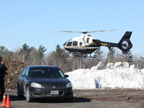 An OPP helicopter lands at Henvey Inlet First Nation on Wednesday March 18, 2015. John Lappa/Sudbury Star/QMI Agency