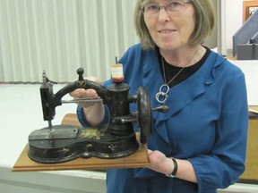 Jacqui Van Meppelen-Scheppink poses with a G.W. Gates sewing machine made in Toronto in 1869. The stencil on the machine is hand-painted. Photo taken Wednesday, March 18, 2015. DON ROBINET/QMI AGENCY