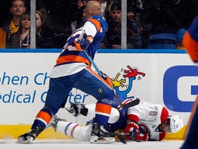 P.K. Subban of the Montreal Canadiens is hit into the boards by Casey Cizikas of the New York Islanders during the first period at the Nassau Veterans Memorial Coliseum on March 14, 2015. (Bruce Bennett/Getty Images/AFP)