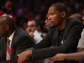 Injured player Kevin Durant of the Oklahoma City Thunder looks on from the bench during the game against the Los Angeles Lakers at Staples Center on March 1, 2015. (Stephen Dunn/Getty Images/AFP)
