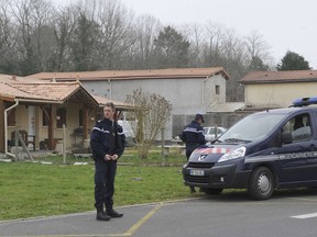 French police officers stand outside the house where the bodies of five babies were discovered in Louchats in southwestern France on March 20, 2015. Police discovered the bodies in a house in southwestern France, a source close to the case said, in what appears to be the country's worst incident of infanticide in five years. The 40-year-old father was taken into custody while the 35-year-old mother was hospitalised, the source said. AFP PHOTO / MEHDI FEDOUACH