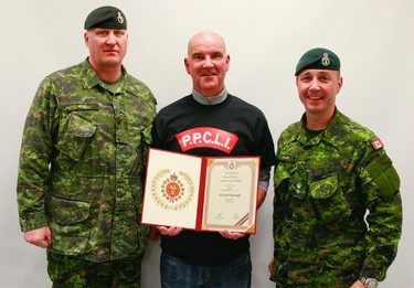 Nigel Wainwright, Edmonton Sun Director of Circulation is presented with a certificate of participation by LCol Stalker, right, and RSM Hessell, left, after taking part of the Soldier for a Day (SFAD) program in CFB Wainwright, Alta., along with 1 PPCLI soldiers who were wrapping up a 10-day high-impact training exercise, Exercise Patricia Villain. Grant Cree/Special to the Edmonton Sun