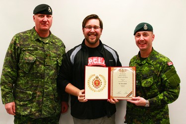 Trevor Robb, Edmonton Sun multi-media journalist is presented with a certificate of participation by LCol Stalker, right, and RSM Hessell, left, after taking part of the Soldier for a Day (SFAD) program in CFB Wainwright, Alta., along with 1 PPCLI soldiers who were wrapping up a 10-day high-impact training exercise, Exercise Patricia Villain. Grant Cree/Special to the Edmonton Sun