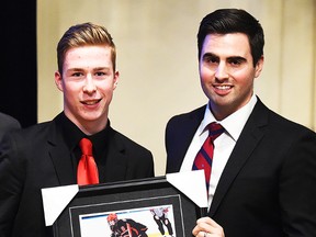 Brady Gilmour (left) receives the OMHA/ETA Player of the Year award from the OHL's Adam Dennis. (Aaron Bell/OHL Images)