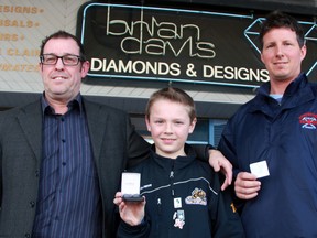 Sarnia Sting novice tier I teammates Garrett Van Rooyen, middle, and Josh Glavin made a presentation to convince local jewelry store owner Brian Davis, left, to donate a half-carat diamond pendant they could raffle off to help raise funds for their hockey team. The winning ticket was purchased by Sarnia's John Jacques, right. (Terry Bridge, The Observer)