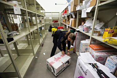 Border services officer Jennifer Kennedy opens a confiscated box at the Canada Border Services Agency at the Edmonton International Airport in Leduc, Alta., on Thursday, March 5, 2015. Codie McLachlan/Edmonton Sun/QMI Agency