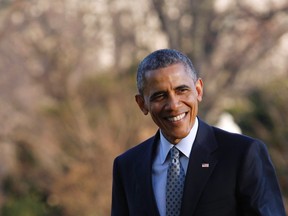 U.S. President Barack Obama smiles as he walks on the South Lawn of the White House in Washington, upon his return after a one-day trip to Cleveland, Ohio March 18, 2015. (REUTERS/Yuri Gripas)