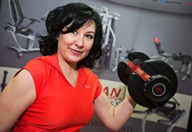 Carolee Clements curls a weight at Flaman Fitness during the Edmonton Home and Garden Show at the Edmonton Expo Centre in Edmonton, Alta., on Friday, March 20, 2015. Codie McLachlan/Edmonton Sun/QMI Agency