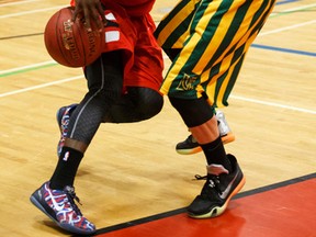 Jasper Place guard Nigel Warden tries to drive past LCI Rams Brady Nelson during 4A provincial championship action this week at jasper Place high school. (Ian Kucerak, Edmonton Sun)