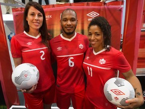 (left to right) Canadian National Soccer Team members Emily Zurrer, Julian de Guzman and Desiree Scott model the new Canada kit that Canada’s National Soccer Teams will be wearing in 2015, during a press conference at the West Edmonton Mall Sport Chek on Friday. (David Bloom, Edmonton Sun)