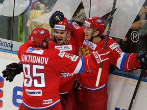 Russia's Nikita Soshnikov (right) celebrates with goal-scorer Anton Lazarev (centre) and Andrei Loktionov (left) during a Euro Hockey Tour game against the Czech Republic in Prague on Feb. 7, 2015. Soshnikov has been signed by the Maple Leafs. (DAVID W. CERNY/Reuters files)