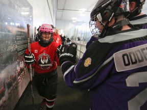 Ottawa Capital City Condors' Madison Austin bumps fists with an Orangeville Wolves' player after finishing her game against the North York Gladiators, Thursday, Mar. 20, 2015 at the 2015 Ottawa Special Hockey International tournament held at Bell Sensplex. The tournament is host to 73 teams from three countries and runs Mar. 19 through 21. Andrew Meade/ Ottawa Sun