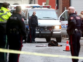 Calgary police investigate after a man was shot believed to be by the police in downtown Calgary, Alta. on Saturday March 21 2015. Darren Makowichuk/Calgary Sun/QMI Agency