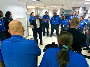 Transportation Security Administration (TSA) Acting Administrator Melvin Carraway (C) meets with TSA officers at New Orleans International Airport in New Orleans March 21, 2015. Richard White, the man who wielded a machete and attacked security agents at a New Orleans airport on Friday evening, has died in the hospital where he was being treated for three gunshot wounds, police said on Saturday.  REUTERS/TSA/Handout via Reuters