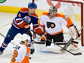 Edmonton's Taylor Hall (4) can't get past Philadelphia's goalie Steve Mason (35) during the third period of the Edmonton Oilers' NHL hockey game against the Philadelphia Flyers at Rexall Place in Edmonton, Alta., on Saturday, Dec. 28, 2013. The Flyers won 4-3. Codie McLachlan/Edmonton Sun/QMI Agency