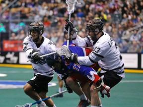 Toronto Rock's Stephan Leblanc is sandwiched between Edmonton Rush players Nik Bilic and John LaFontaine in National Lacrosse League action in Toronto, Ont. on Saturday March 21, 2015. Michael Peake/Toronto Sun/QMI Agency