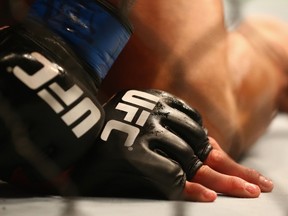 A file photo of the detail of gloves worn by Anthony Pettis and Rafael dos Anjos in the Lightweight Title bout during the UFC 185 event at American Airlines Center on March 14, 2015 in Dallas, Texas.  Ronald Martinez/Getty Images/AFP/Files