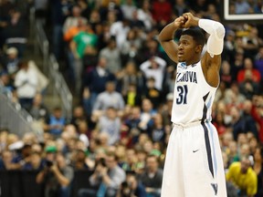 Villanova guard Dylan Ennis of Brampton, Ont., stares off in disbelief after his top-seeded Wildcats were eliminated from the NCAA tournament with a 71-68 loss to North Carolina State on Saturday night in Pittsburgh. (REUTERS)