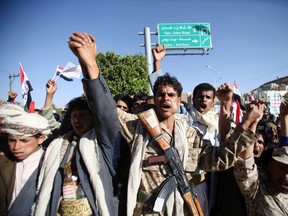 Houthi fighters in army uniform shout slogans as they march during a demonstration against the U.S. and the U.N. Security Council in Sanaa February 20, 2015. (REUTERS/Mohamed al-Sayaghi)
