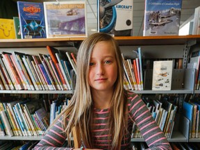 11 year old Stouffville, Ont. resident, Nadine Carter, sits at the local library where she started her research on Canadian World War -1 Ace Roy Brown who was most famous for the shooting down of German Ace, Baron Manfred von Richthofen, also known as the Red Baron in 1918. Her research ended in finding the unmarked grave of Roy Brown in Toronto after his body had been removed from its Stouffville plot. On Tuesday March 17, 2015. Dave Thomas/Toronto Sun/QMI Agency