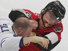 Ottawa Senators Mark Borowiecki fights Toronto Maple Leafs Zach Sill during third period action at the Canadian Tire Centre in Ottawa on Saturday March 21, 2015. The Ottawa Senators defeated the Toronto Maple Leafs 5-3.   
Tony Caldwell/Ottawa Sun/QMI Agency