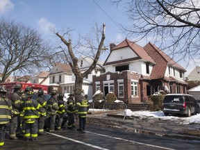 Firefighters stand outside a home hours after it caught fire in the Midwood neighborhood of Brooklyn, New York March 21, 2015. In one of New York City's deadliest fires in years, seven children from the same Orthodox Jewish family died early on Saturday when flames ripped through their Brooklyn home, officials said. The blaze, which erupted just before 12:30 a.m., appeared to have been started accidentally by a hot plate, which are used by many Orthodox families to warm food on the Sabbath, said Fire Commissioner Daniel Nigro. REUTERS/Stephanie Keith