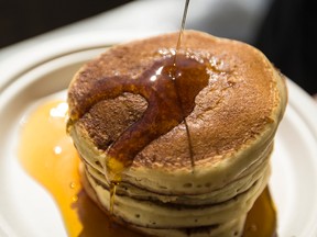 Fresh maple syrup being poured onto a stack of pancakes at Stanley's Olde Maple Lane Farm in Edwards, Ont., which is about 38 km south west of Ottawa, March 19, 2015. (Errol McGihon/QMI Agency)