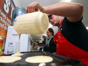 Josh Nicholson pours pancake batter during the Huntingdon Firefighters' Assoc. 30th-annual pancake breakfast in Ivanhoe, Ont. Sunday, March 22, 2015. About 900 to 1,000 diners were expected.