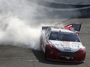 Brad Keselowski,  celebrates with a burnout after winning the NASCAR Sprint Cup Series Auto Club 400 at Auto Club Speedway in Fontana, Calif., yesterday. (AFP)