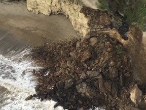 The collapsed section of the Arch Rock overlook at the Point Reyes National Seashore, about 40 miles northwest of San Francisco is shown in this handout photo released to Reuters March 23, 2015. One hiker was killed and another injured when a seaside cliff collapsed at a park in California and sent giant boulders and earth plunging onto the beach below, officials have said.  REUTERS/Sonoma County Sheriff Department/Handout via Reuters