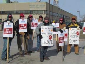Members of Unifor Local 672 picket at the Imperial Oil gate on Monday March 23, 2015 in Sarnia, Ont. Approximately 35 employees of SGS, a company that loads and unloads shipments at the site, went on strike at midnight Friday. Paul Morden/The Observer/QMI Agency