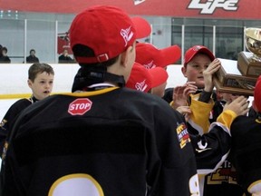 The Mitchell Pee Wee AE hockey team, sponsored by New Orleans Pizza, captured the Ontario Minor Hockey Association (OMHA) Group 4 AE championship Saturday with a dramatic 3-2 overtime victory over Durham (CYO) in Oshawa, completing a three-game sweep in the best-of-five, six-point final series. SUBMITTED