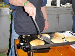 Mike Van Loon of the Dublin Lions Club flips pancakes. KRISTINE JEAN/MITCHELL ADVOCATE