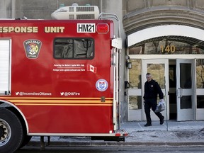A member of the Ottawa Fire Services hazardous materials team leaves the Victoria Building, which house Senate offices, in Ottawa March 23, 2015. (REUTERS/Chris Wattie)