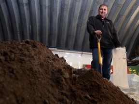 Public works manager Allan Broek holds a sandbag and shovel while standing on the sand pile in the public works building in Tweed Monday. The municipality held an open house Monday evening and has posted information on its website to help residents prepare for any spring flooding.