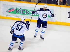 Drew Stafford, right, and Tyler Myers have been able to contribute offensively since joining the Jets lineup. (USA TODAY SPORTS)