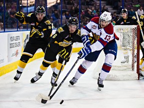Oil Kings forward Brandon Baddock battles Wheat Kings' Ryan Pilon during a January game at Rexall Place. The two teams meet in the first round of the playoffs. (Codie McLachlan, Edmonton Sun)