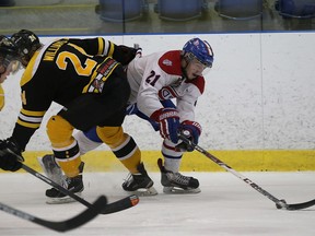 Kingston Voyageurs’ Cole Bolton tries to get past Aurora Tigers defenceman Eric Williams during Game 6 of an Ontario Junior Hockey League North-East Conference semifinal playoff series at the Invista Centre on Sunday. (Ian MacAlpine/The Whig-Standard)