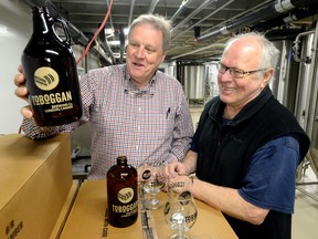 Mike Smith, left, and brewmaster Thomas Schmidt in the basement of  London bar Jim Bob Ray's sampling one of the seven beers they are making. In several weeks, the bar will close and be re-opened as Toboggan. Photo taken on Monday March 23, 2015 (MORRIS LAMONT, The London Free Press)