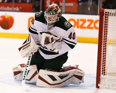 Minnesota Wilds� Devan Dubnyk (40) G makes a chest save during the first period in Toronto on Monday March 23, 2015. Jack Boland/Toronto Sun/QMI Agency