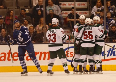 Minnesota Wilds� Charlie Coyle (3) C is congratulated for scoring the opening goal with one minute left during the first period in Toronto on Tuesday March 24, 2015. Jack Boland/Toronto Sun/QMI Agency